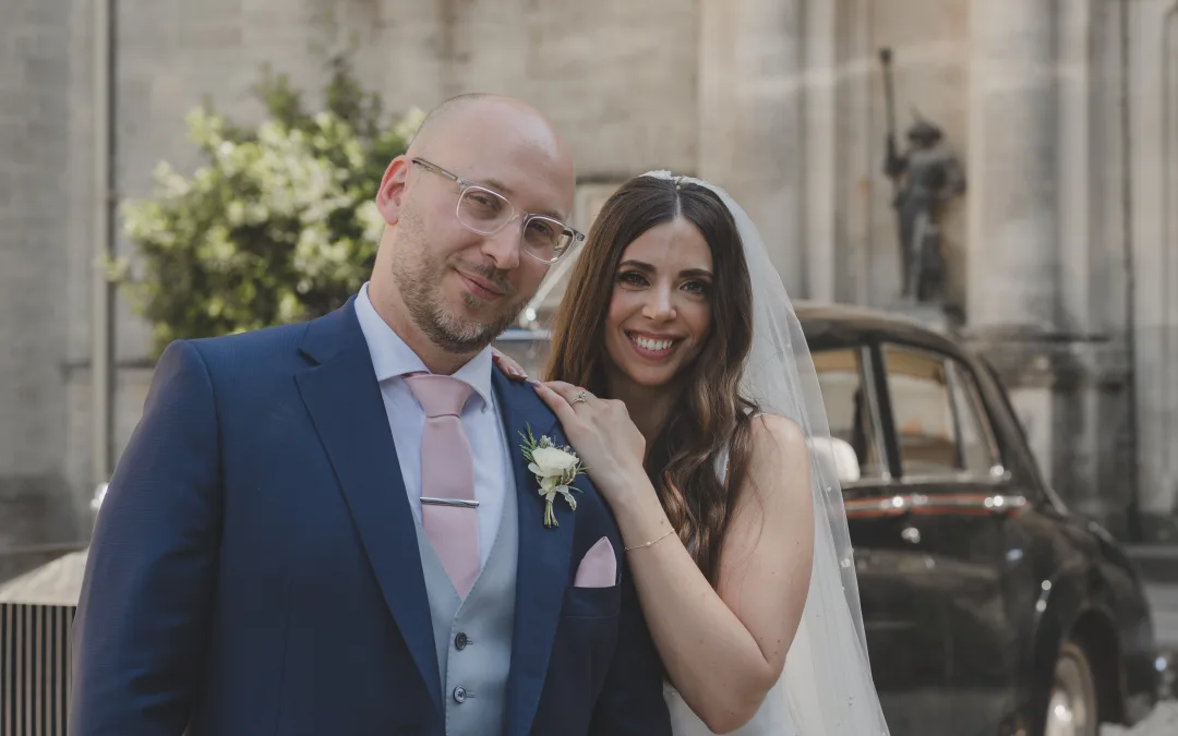 Orchardleigh House Weddings: a man and a woman standing next to each other in front of a car.