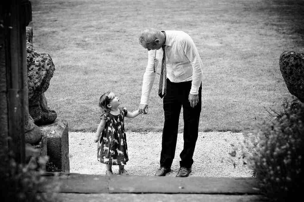 Bath Wedding Photography :a man holding the hand of a little girl.
