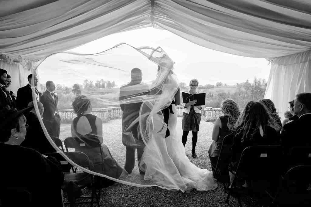Bath Wedding Photography: a bride and groom standing under a tent.