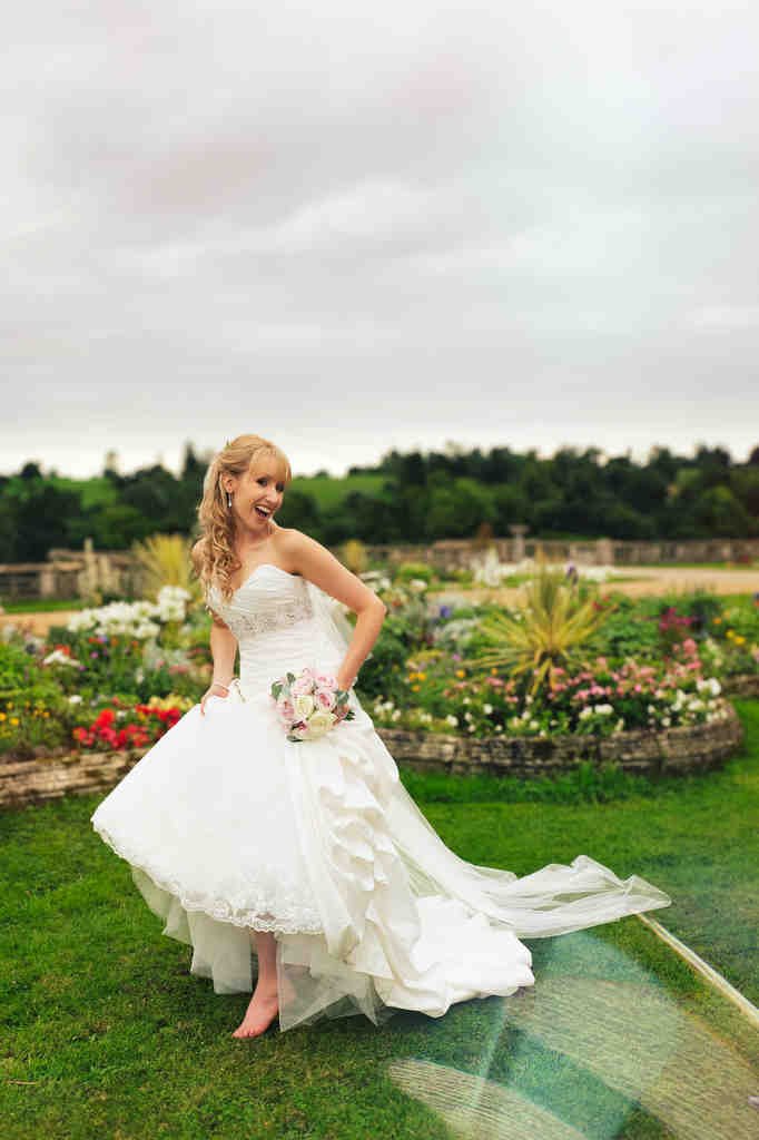 Wedding Photography Bath: a woman in a wedding dress standing in the grass.