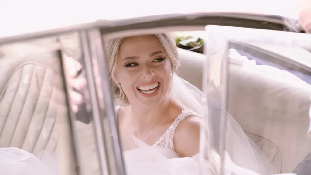 Select the wedding Photographer: a bride smiles as she gets out of a car. Wedding Photographer Bath