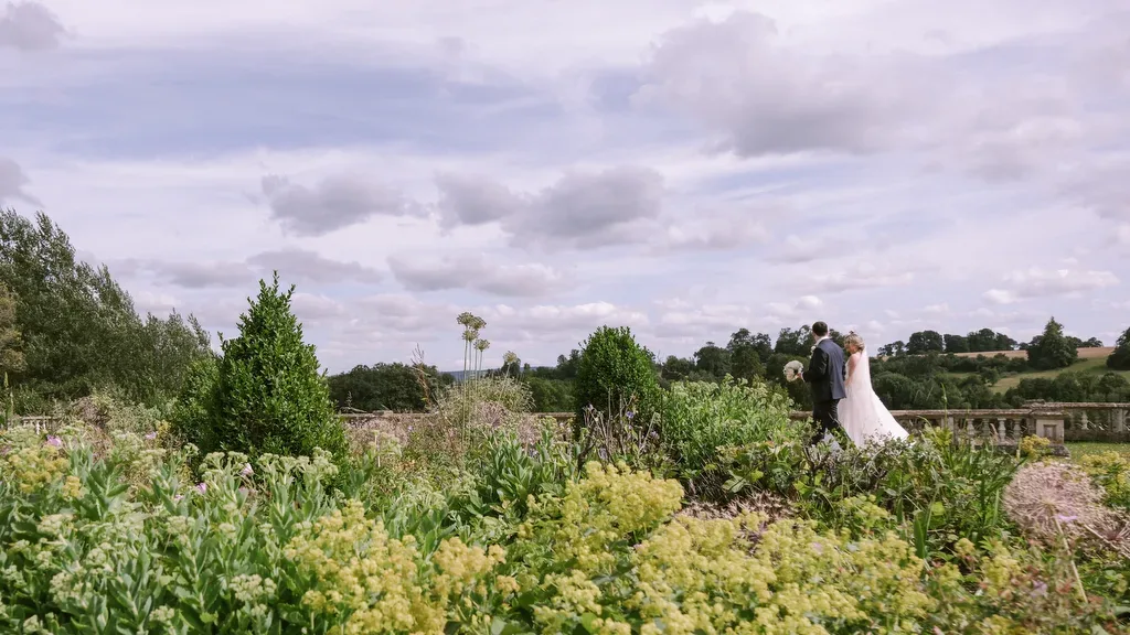 Orchardleigh House: a bride and groom standing in a garden.