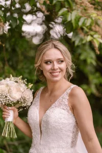 a bride in a wedding dress holding a bouquet.