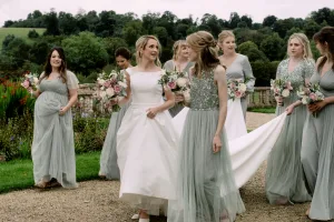Castle Combe Manor Wedding Photographer capturing a group of bridesmaids walking down a path.