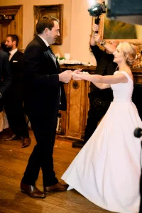 A Castle Combe Manor Wedding Photographer captures the magical moment of a bride and groom dancing at their wedding reception.