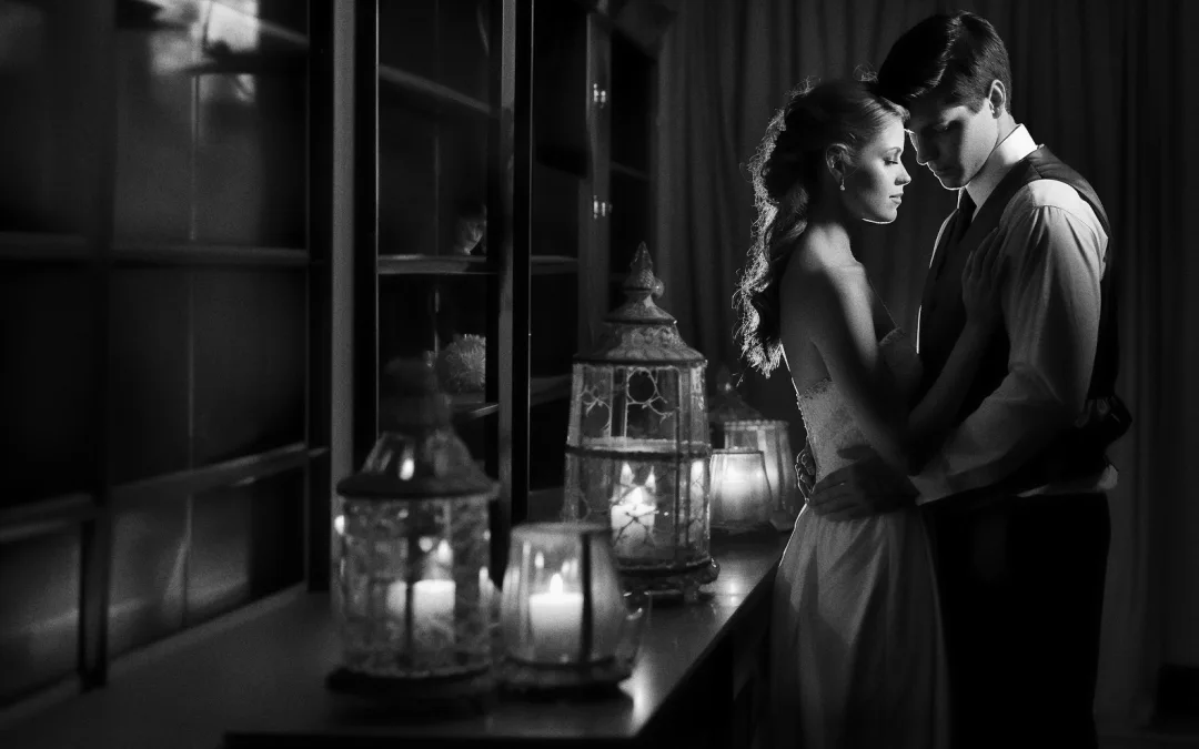A bride and groom embracing in the dark. Low lights in wedding Photography