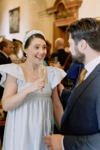 A man and woman in a wedding dress are talking to each other at Orchardleigh House.