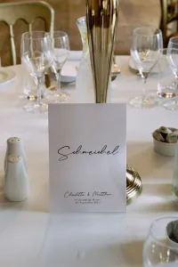 A beautifully arranged table setting at Orchardleigh House, showcasing a place card elegantly placed on top.