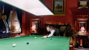 At Orchardleigh House, two men are seen playing a game of billiards in a stunningly decorated room.