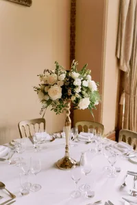 A stunning table setting with white flowers and silverware at Orchardleigh House Wedding Photographer's event.