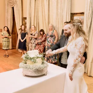 A bride and groom cutting their wedding cake captured by the Orchardleigh House Wedding Photographer.