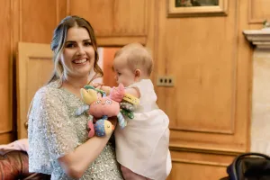 A woman holding a baby in Orchardleigh House.