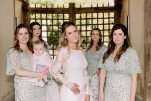 A bride and her bridesmaids pose for a photo at Orchardleigh House.