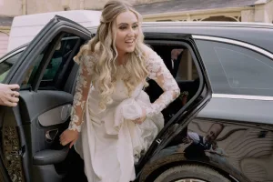 A bride getting out of a car at Orchardleigh House.