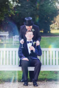 _DSF7808 Two men in tuxedos sitting on a bench at a Orchardleigh Wedding Photography shoot.