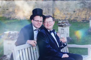 _DSF7817 Two men in tuxedos sitting on a bench at an Orchardleigh wedding.