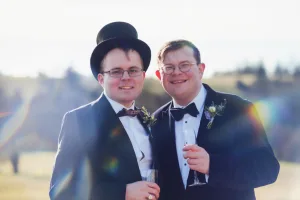 _DSF7857 Orchardleigh Wedding Photography captures the joyous moment of two men in tuxedos beaming at the camera.