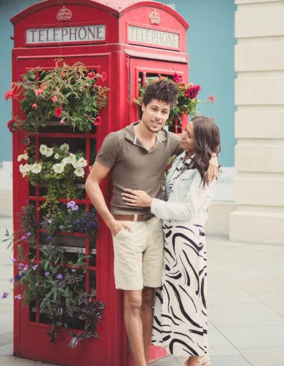 A couple posing in front of a red telephone booth. Wedding Photography Photo-Shoot Bath UK
