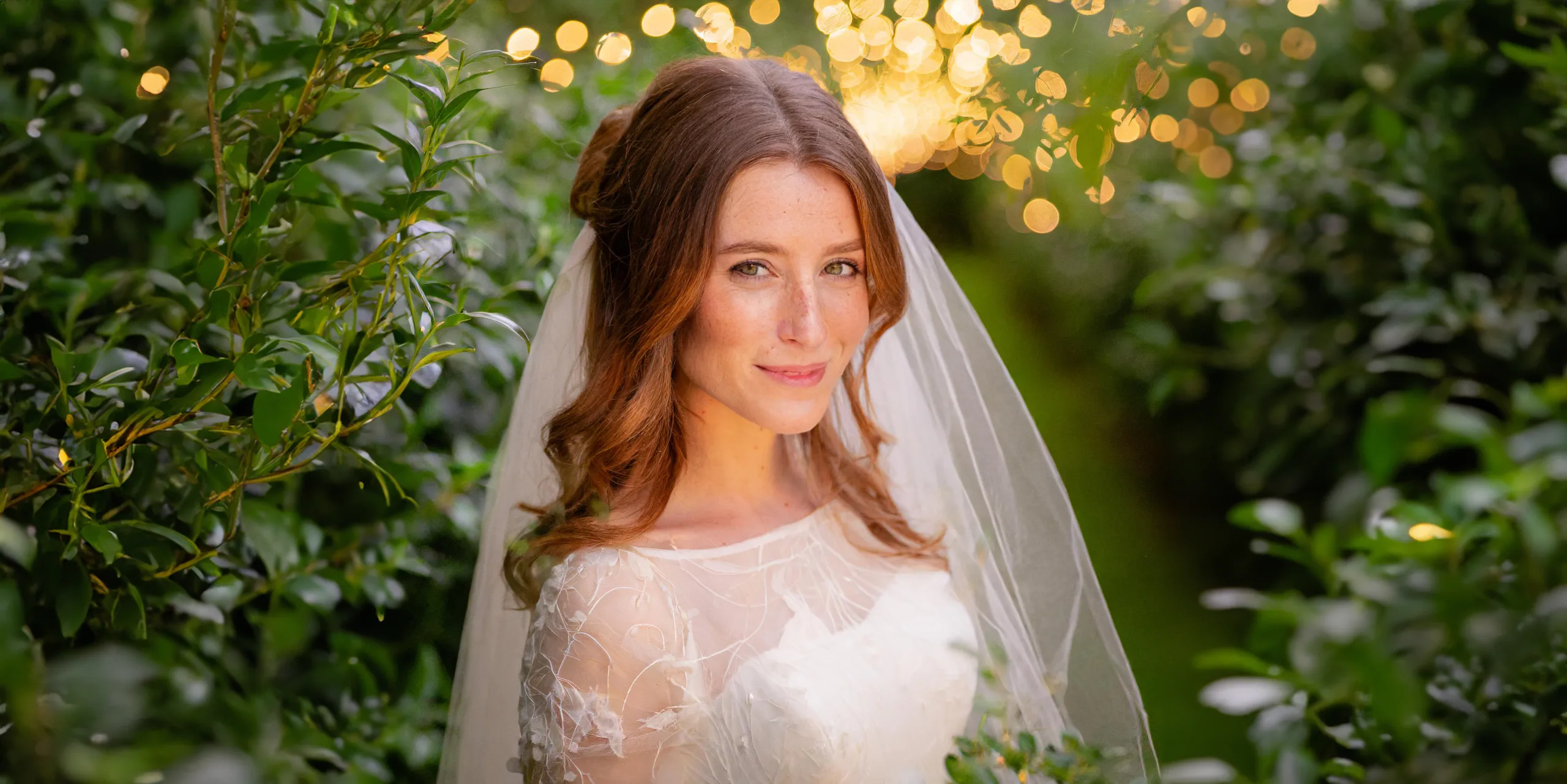 Detailed Photo of a Bride in white dress among greenery Manor House Castle Combe