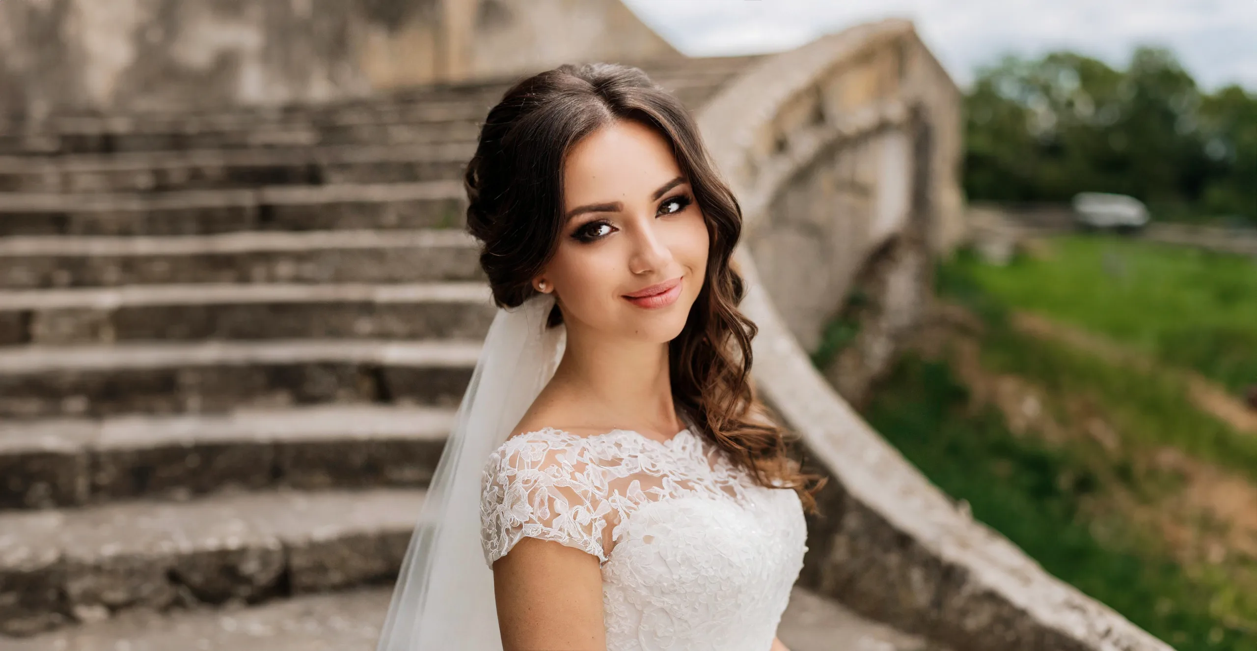 Bride standing on the steps at The Manor Castle Combe Wedding Photographer