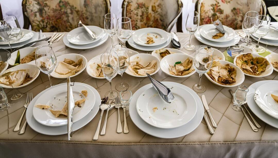 Wedding reception Table after the meal with half eaten dinner plates