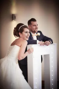 A bride and groom standing in front of a podium capturing their special moments at Orchardleigh House with the skilled eye of a wedding photographer.