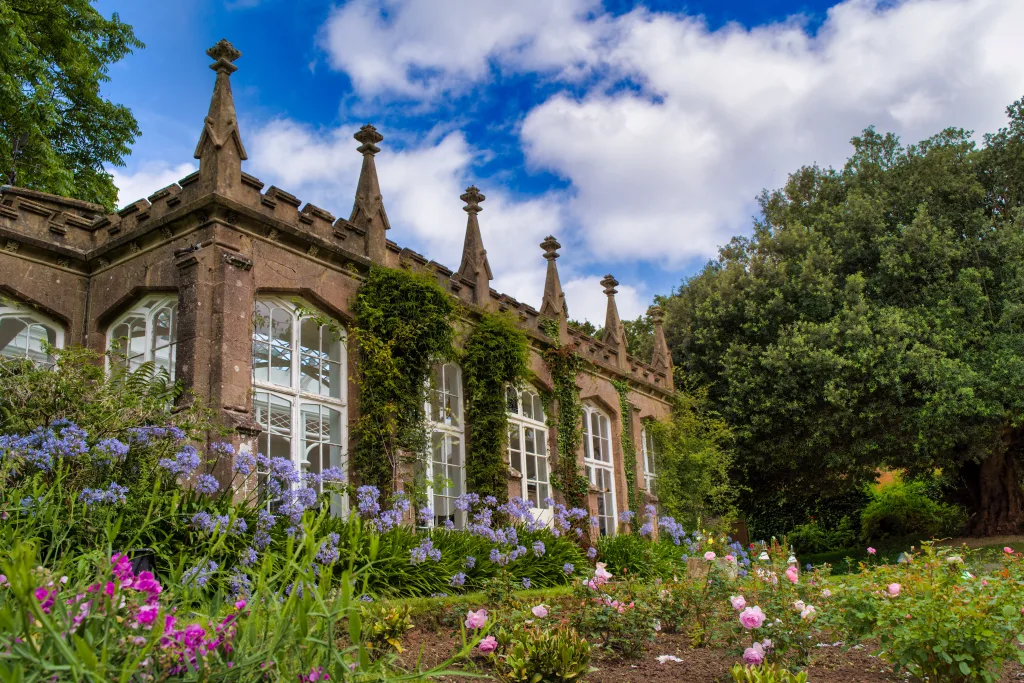 A stone building in St. Andrie's park surrounded by flowers, offering 20% off wedding photography packages.
