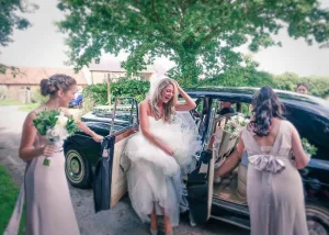 A bride and her bridesmaids arriving at Farleigh House for their wedding, captured by the wedding photographer.