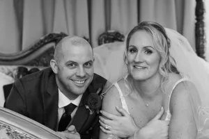 A black and white photo of a bride and groom posing in bed taken by Orchardleigh Wedding Photographer.