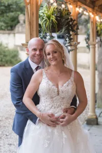 Wedding Photographer capturing a bride and groom posing under a gazebo at Orchardleigh.