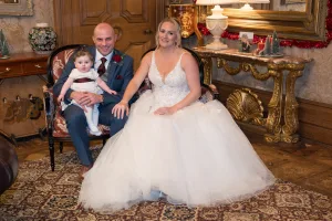 A bride and groom posing for a photo in an ornate room captured by the Wedding Photographer at Orchardleigh.