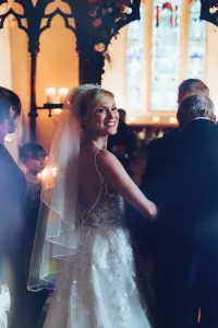 A bride walks down the aisle in Orchardleigh House.