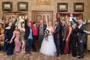 Orchardleigh's wedding photographer captures a picture-perfect moment as the wedding party poses in an ornate room.