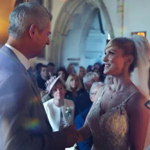 A bride and groom smiling at each other in Orchardleigh House.