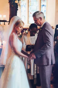 A bride and groom exchanging their vows in a church captured by Orchardleigh House Photos.