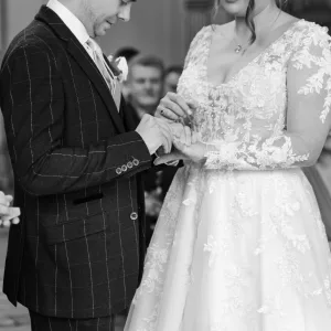The Wedding Photographer captures the special moment as the bride and groom exchange rings during their Orchardleigh wedding ceremony.