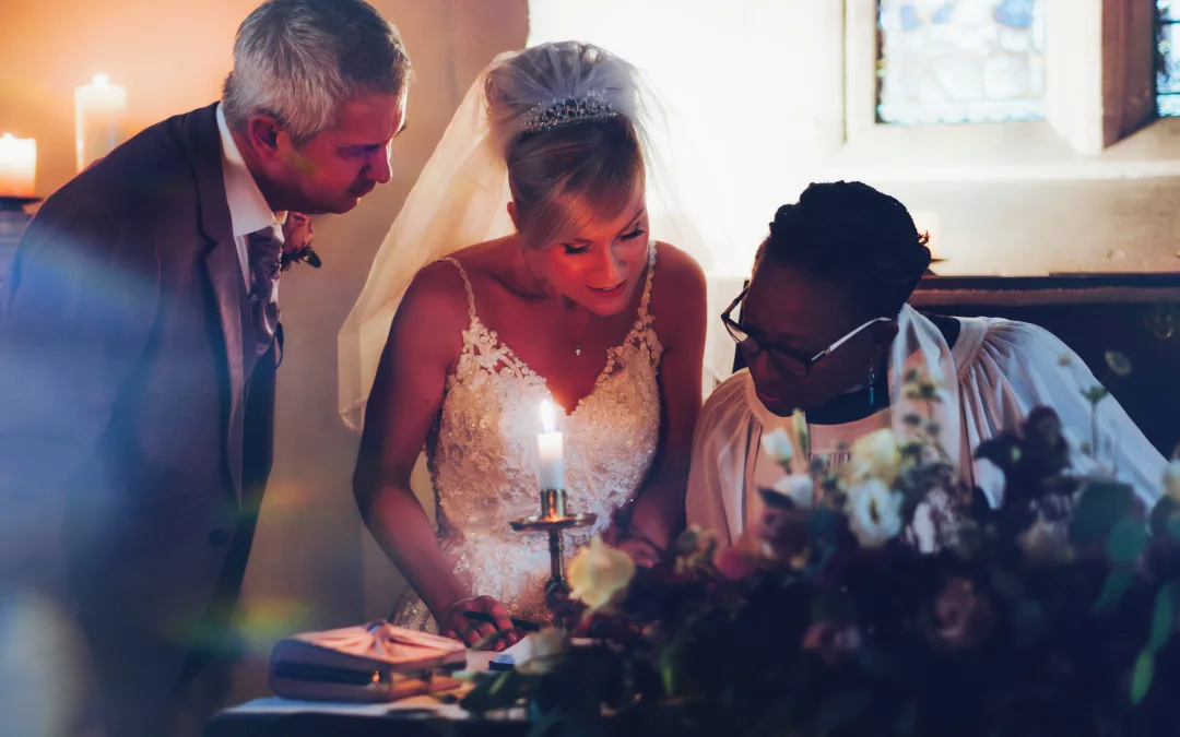 A bride and groom lighting a candle in Orchardleigh House Photos.