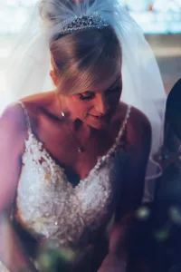 A beautiful bride in a wedding dress glowing at Orchardleigh House while capturing stunning photos.