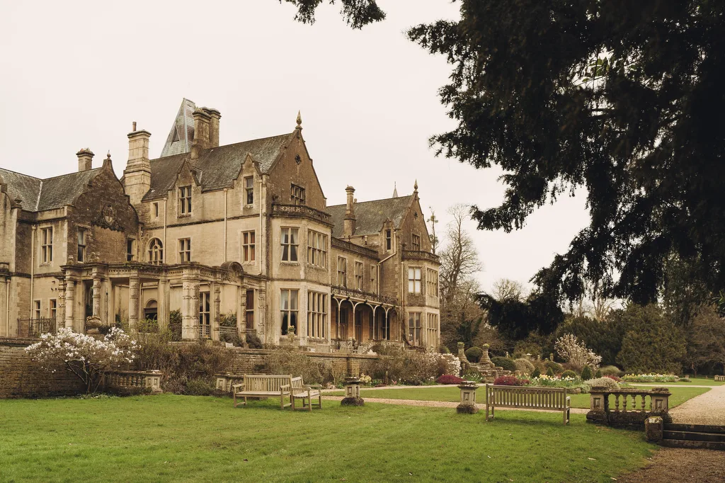 Orchardleigh2 A historic Orchardleigh House with surrounding gardens under a cloudy sky, perfect for weddings.