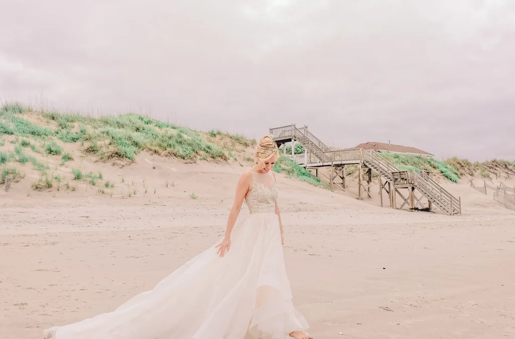 A world-class wedding photographer captures a bride gracefully strolling along the beach in her exquisite wedding dress.