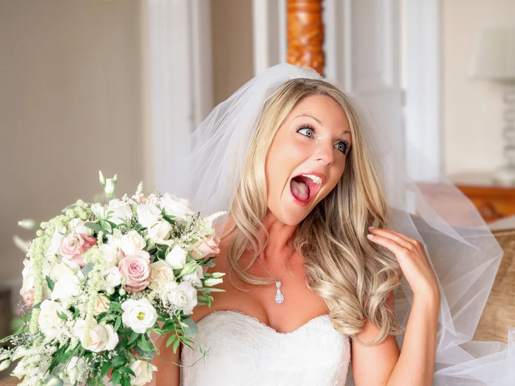 A world-class wedding photographer captures a stunning bride in her exquisite wedding dress with a beautiful bouquet.