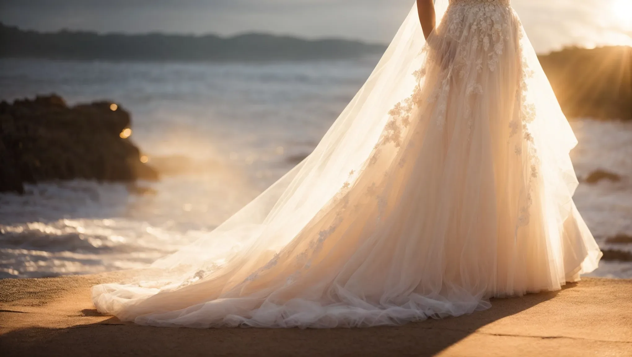 A bride in a wedding dress standing on a cliff overlooking the ocean. Local Wedding Photography Prices