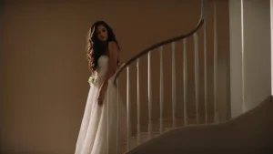 A bride in a white dress standing on a staircase. Wedding Dress 2024 at The Bath Spa Hotel
