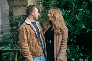 Stourhead Wedding Photographer1 An engaged couple standing in front of a stone wall captured by a Stourhead Wedding Photographer.