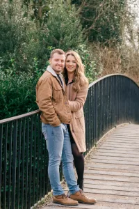 Stourhead Wedding Photographer17 A Stourhead Wedding Photographer capturing a couple posing for a photo on a bridge.
