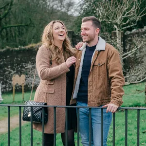 Stourhead Wedding Photographer20 A man and woman, captured by a talented Stourhead Wedding Photographer, standing next to a fence in a park.