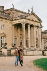 Stourhead Wedding Photographer26 A couple standing in front of a grand Stourhead mansion, captured by a skilled Wedding Photographer.