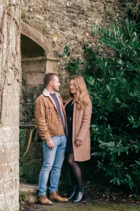 Stourhead Wedding Photographer7 Stourhead Wedding Photographer capturing an engaged couple standing in front of a stone archway.
