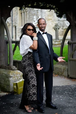 www.thefxworks.co.uk A man in a black tuxedo and a woman in a black dress elegantly pose for their Orchardleigh wedding photography.