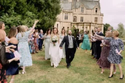 A bride and groom walk down the aisle at their Orchardleigh House wedding, captured beautifully by a talented photographer.